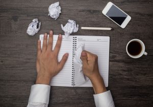 Persona arrancando hojas de un cuaderno